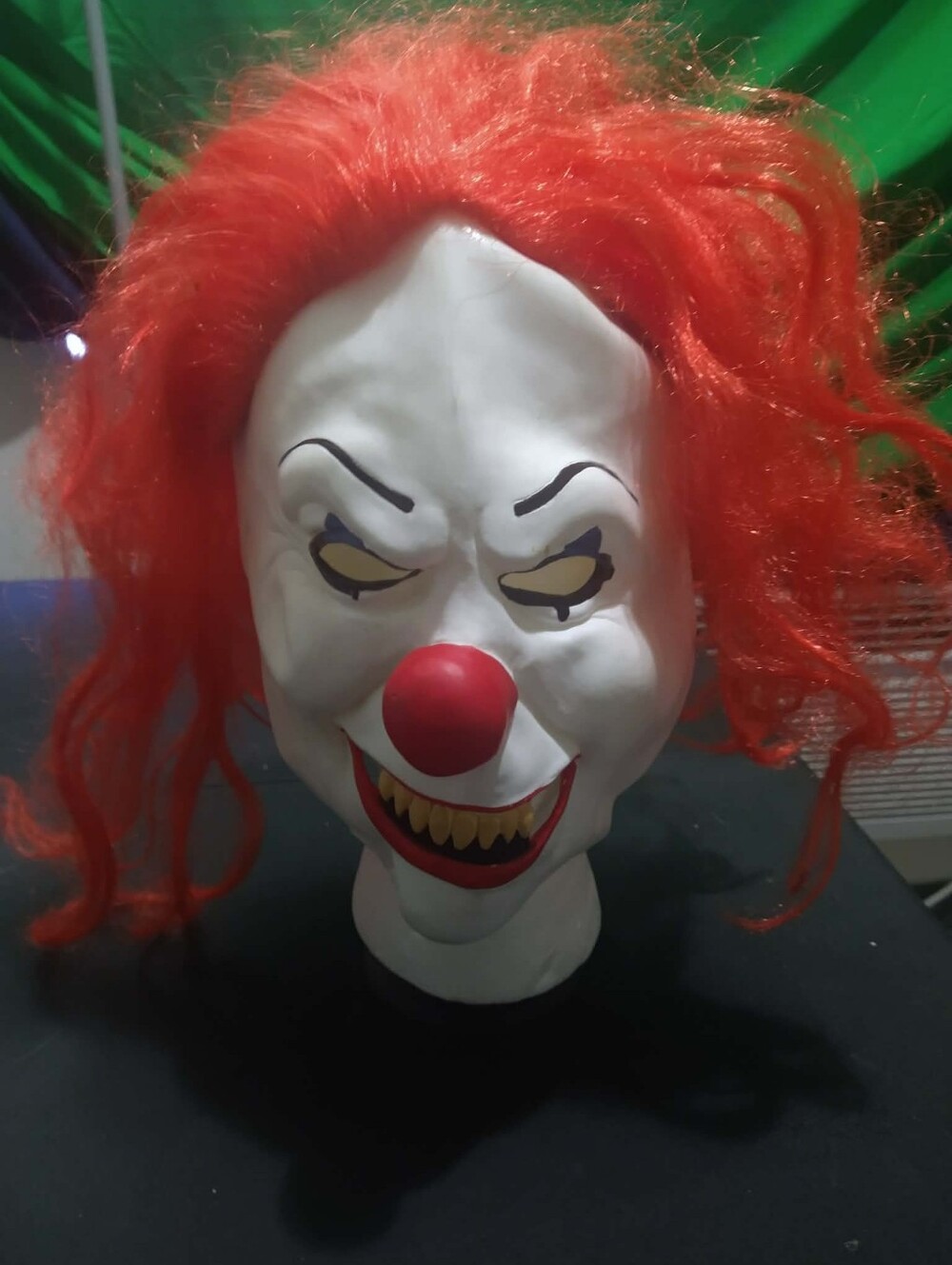 Warner Bros. / Rubie’s scary clown latex mask with bright red synthetic hair